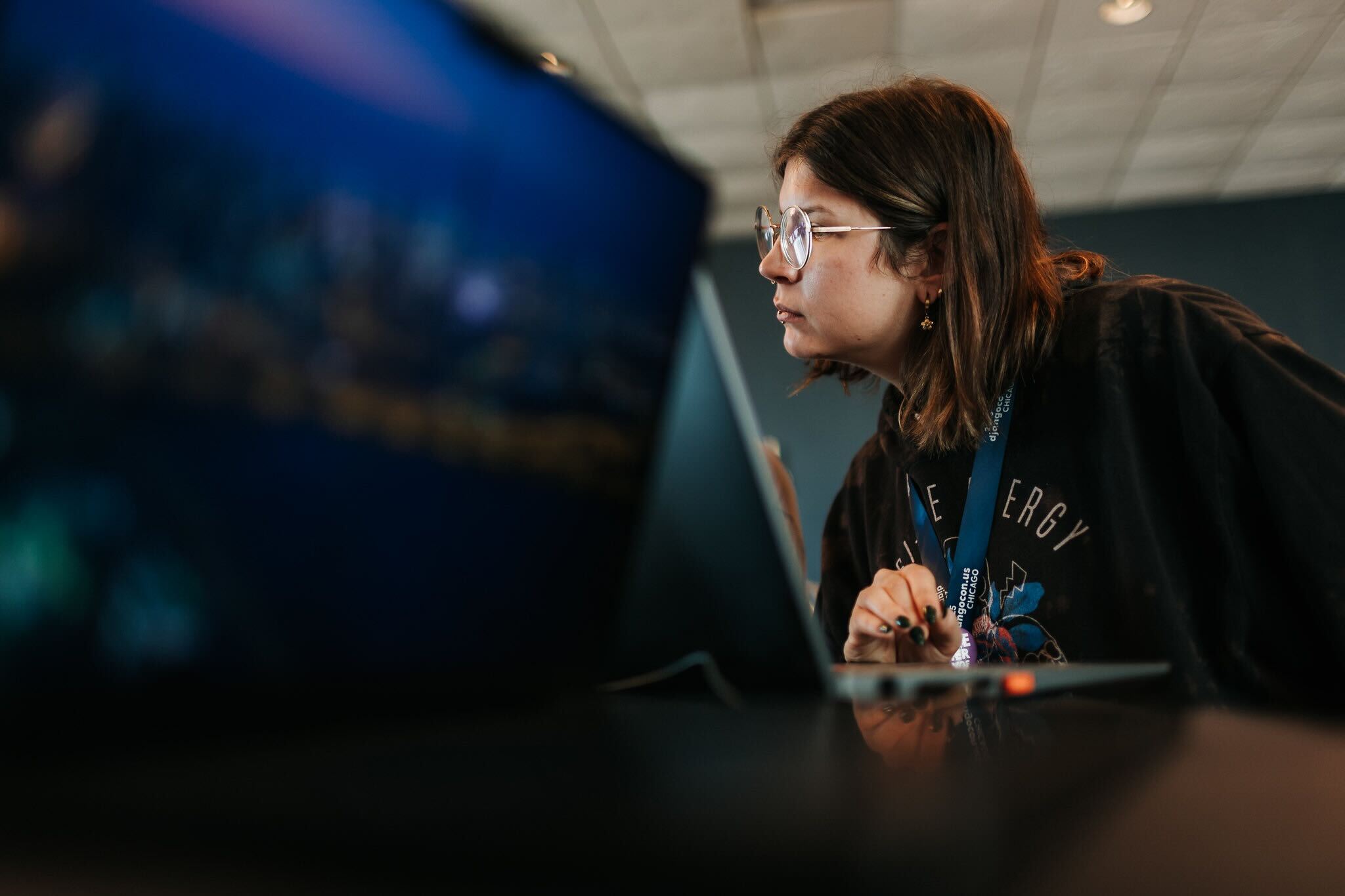 A sprinter focused on their laptop at DjangoCon US.