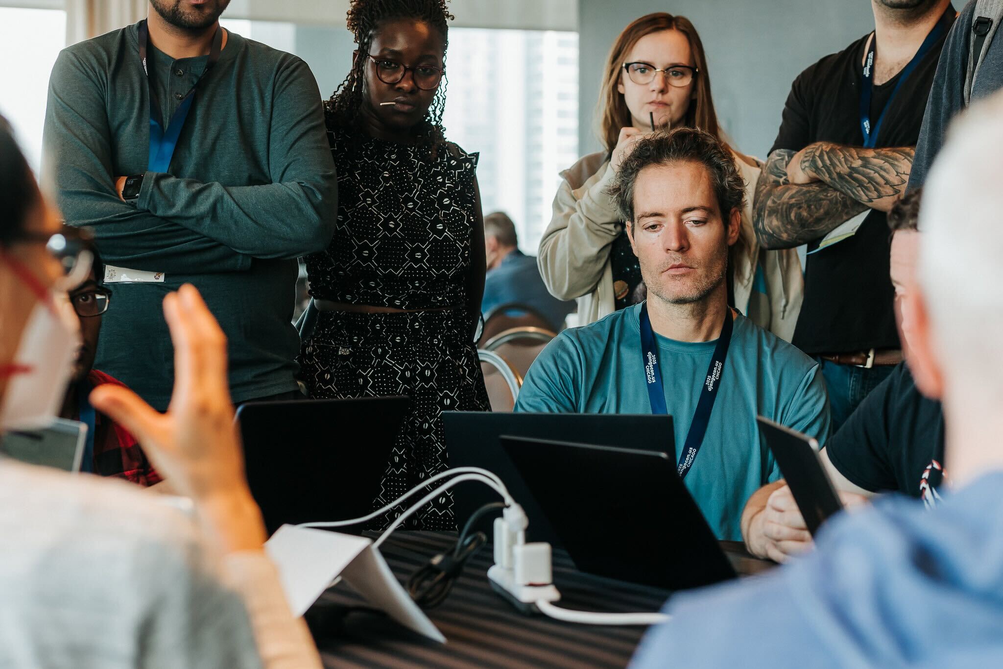 A group of attendees gathered around a table during a sprint session.